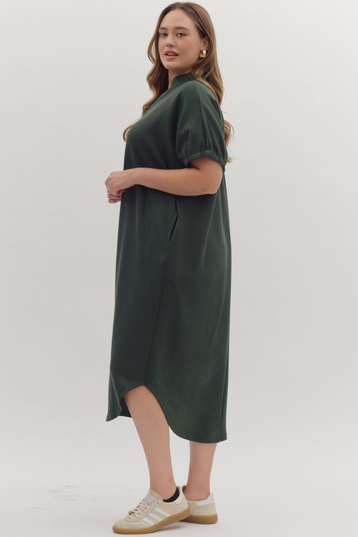 Collie Midi Dress in dark green, round neckline, short gathered sleeves, curved high-low hem, lightweight knit. Available in all sizes.