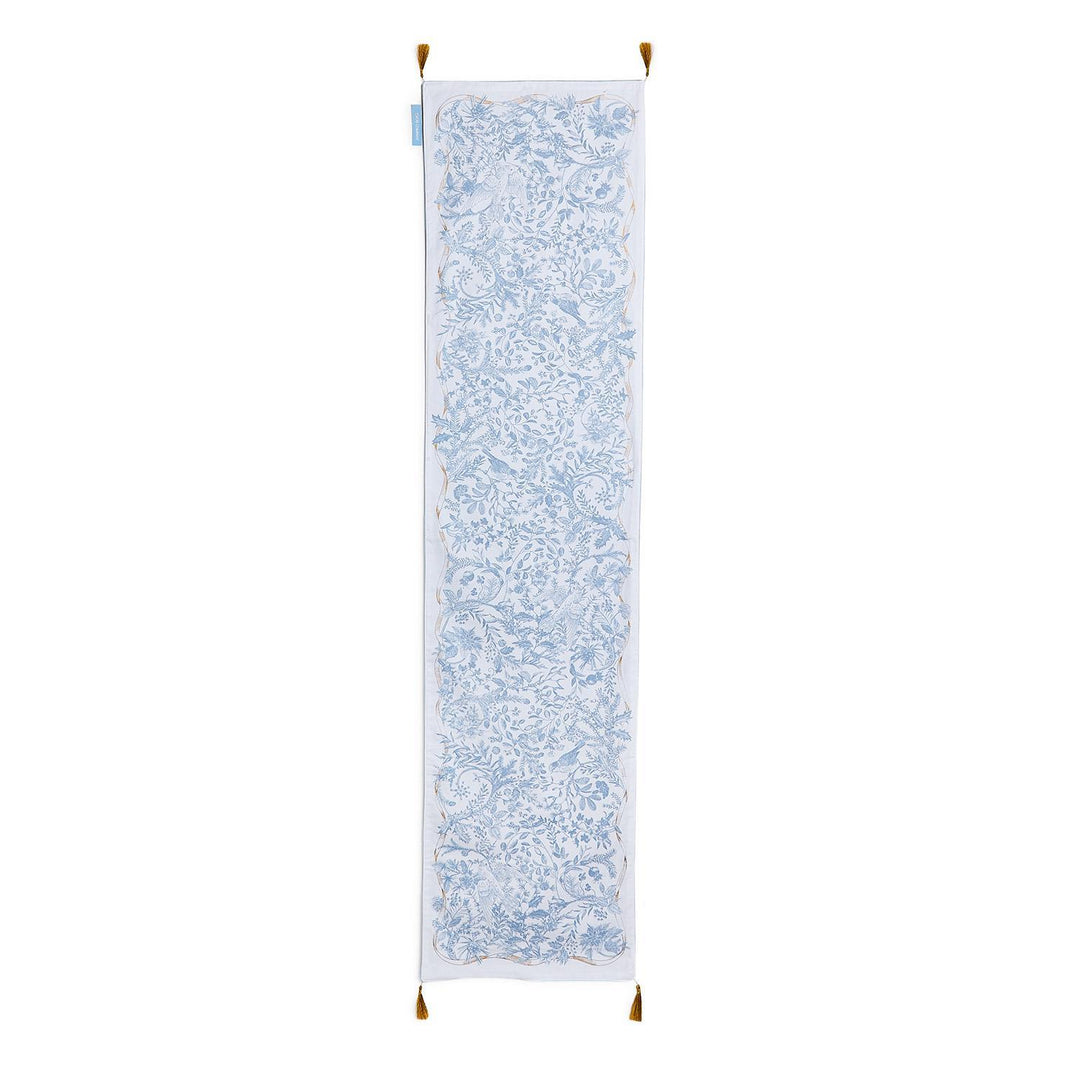 Gilded Cottage Double-Sided Table Runner with a rectangular blue and white floral toile pattern, gold border, and corner tassels.