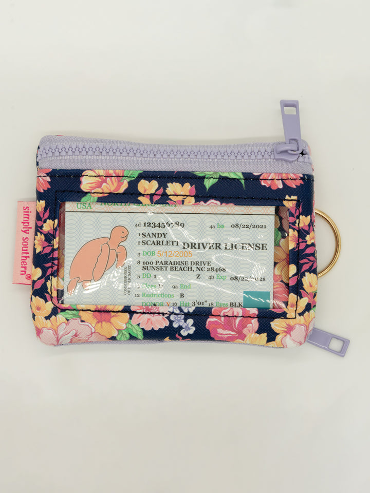 Small floral zippered keychain wallet with clear ID window, keyring, and pink "simply southern" tag. Available in one size.