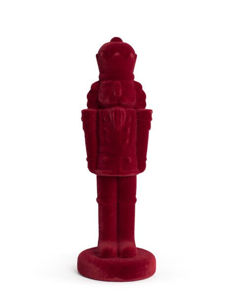 Deep red Theodore Nutcracker figurine on a round base.