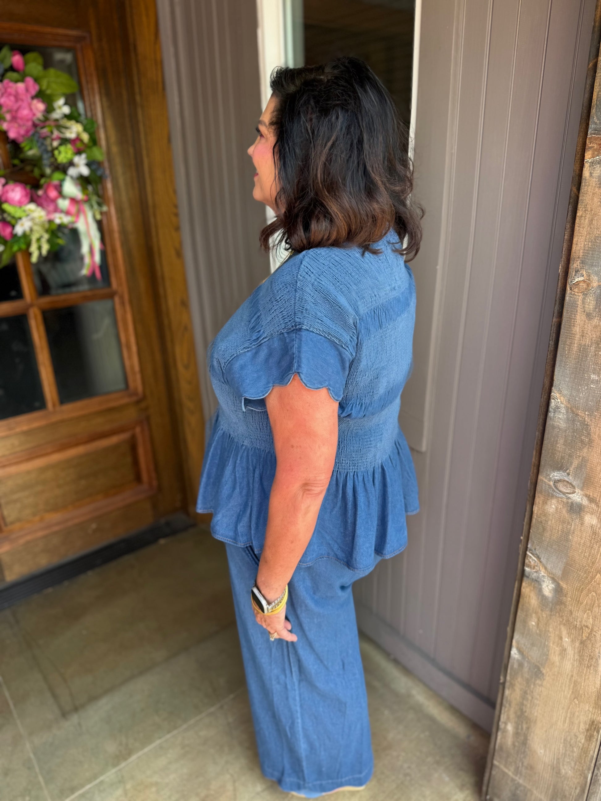 Blaire Chambray Smocked Peplum Top in blue, available in sizes XS-XL.