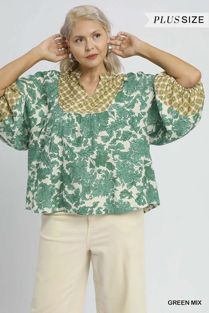 Annie Abstract Print Top: relaxed fit, green floral patterns, wide sleeves, yellow-green geometric neckline. Sizes XS-XL.