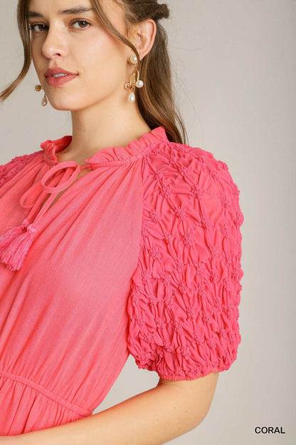 Coral Linen Midi Dress: A-Line silhouette, smocked short sleeves, tassel-tied neckline, gathered waist. Sizes available: XS, S, M, L.