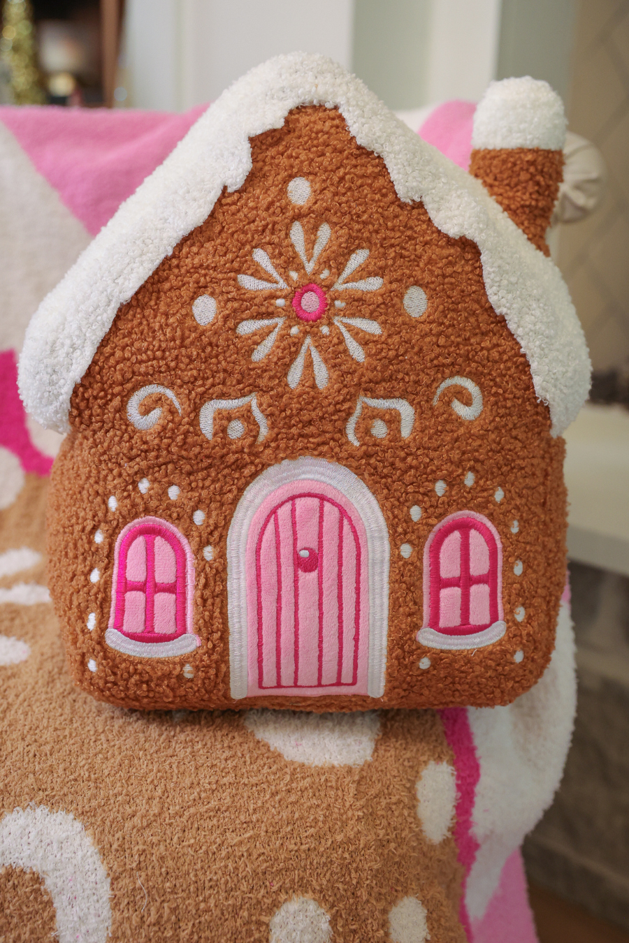 Gingerbread House Pillow with white icing, pink door, and two windows. Available in multiple sizes.