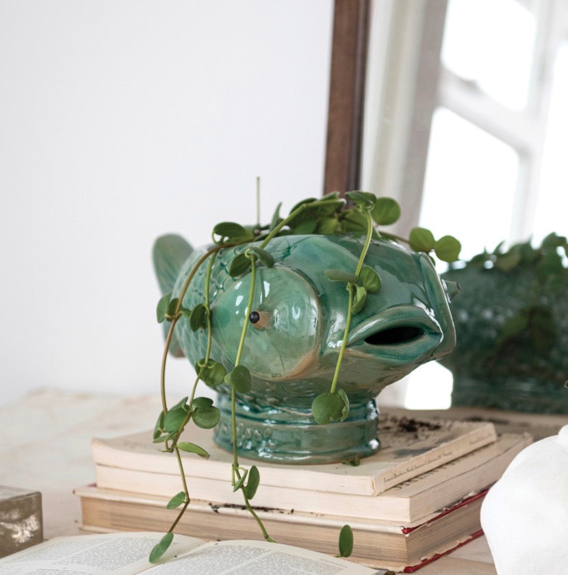 Turquoise ceramic fish-shaped planter, available in multiple sizes.