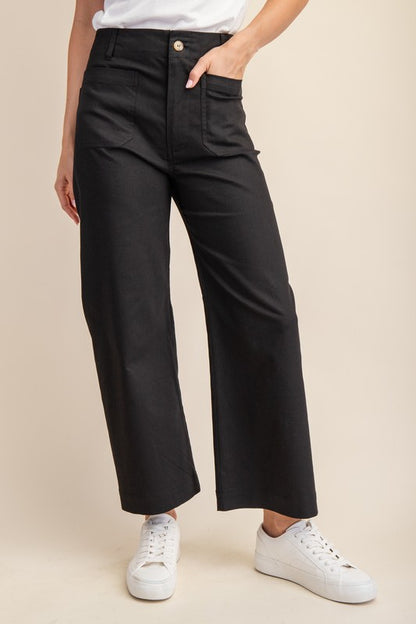 High-waisted black ankle-cropped summer pants, wide legs, front pockets, button-zip. Stretchy denim. Sizes: XS-XL.