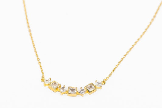 Alana 18k Gold Necklace with five square-cut gemstones on a curved bar. Available sizes: 16", 18", and 20".