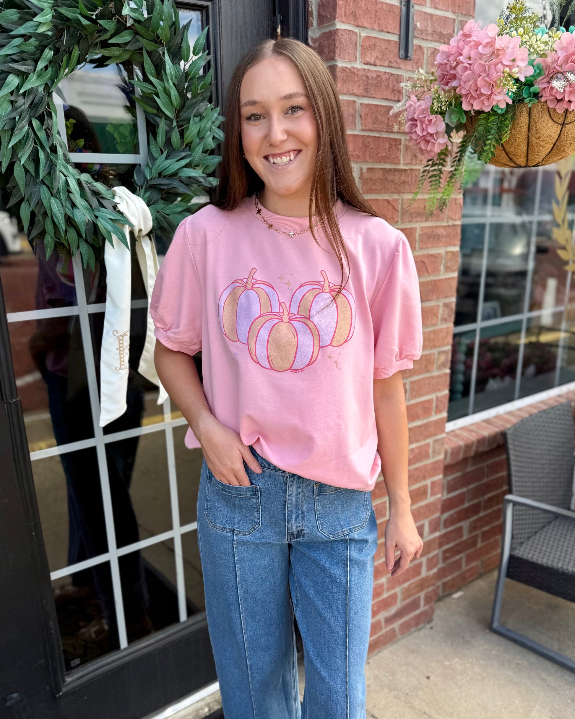 Pink Pumpkin Short Sleeve Sweatshirt with three pumpkins printed on the front. Available in sizes S-XXL.