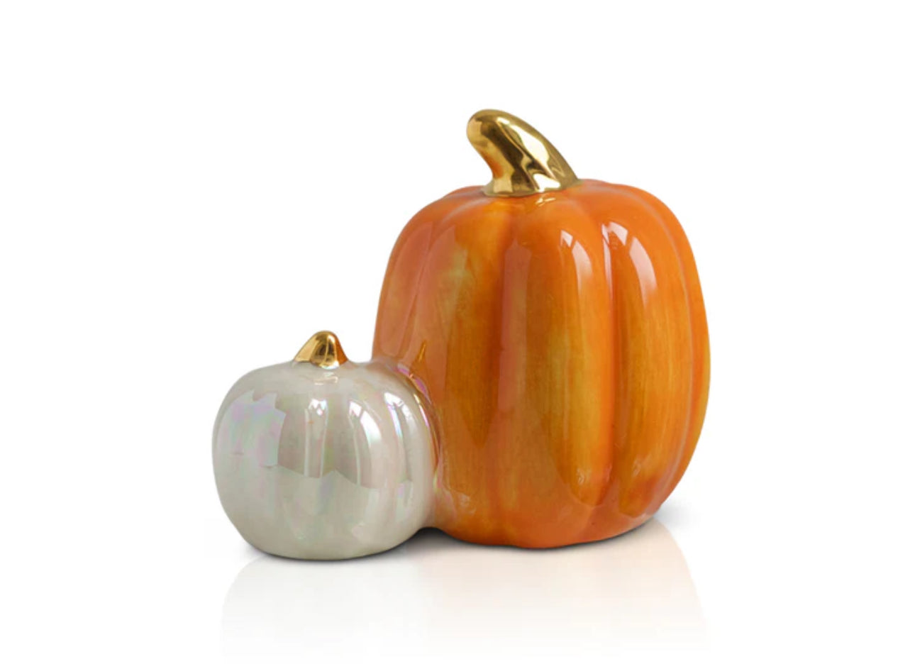 Nora Fleming Minis ceramic decoration includes a small pearly white pumpkin and a larger orange one, both with shiny gold stems. Sizes available: Small Pumpkin (approximately 1.5 inches tall) and Large Pumpkin (approximately 2 inches tall).