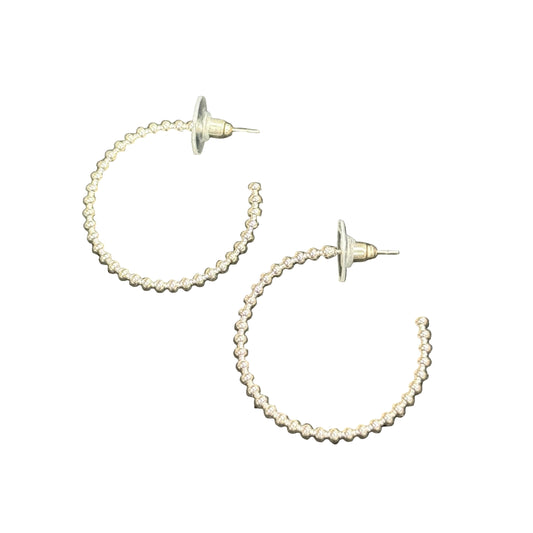 The Ruth Beaded Hoop Earrings feature a textured gold finish and are available in multiple sizes.