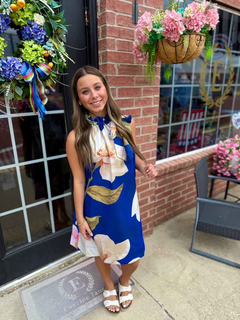 Royal Blue Floral Ruffle Tie-Neck Sleeveless Dress, available in sizes XS–XL.