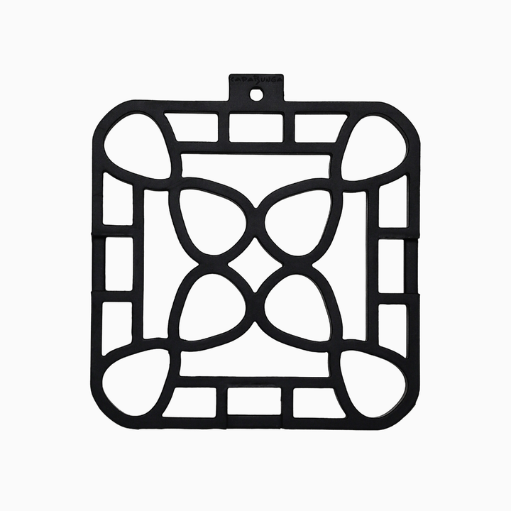 Black, square, heat-resistant trivet with geometric cut-out pattern; available in multiple sizes.