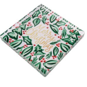 Merry Christmas Holly Napkin Weight, square clear acrylic with green and red pattern and gold script lettering.
