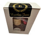 A white box with a black and gold label displaying the name "Everlee Jane" and a decorative letter "E" at the top with laurel branches. The box has a clear window showing stacked circular cookies inside. The word "Car Diffusers" is printed on the bottom inside the window, reminiscent of car diffusers for a peaceful drive. Sizes available: N/A.
