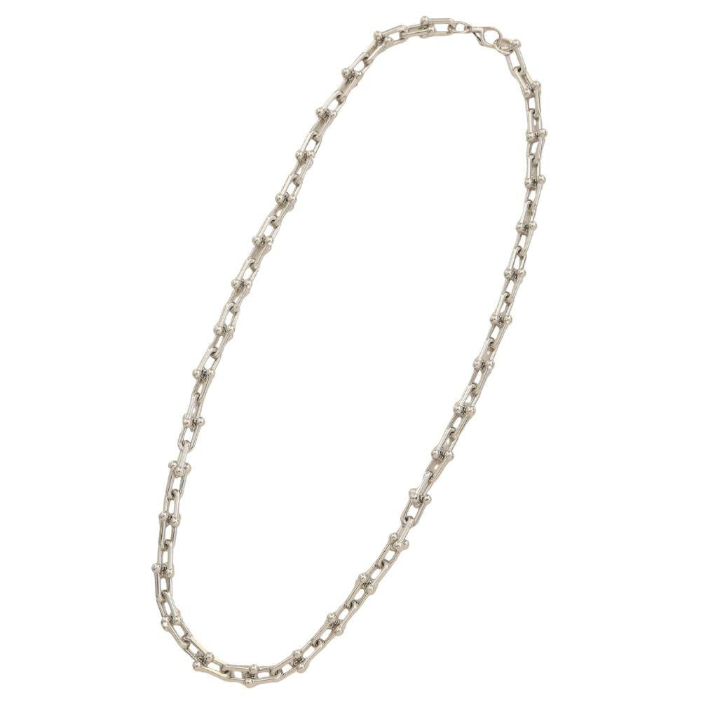 Gold-dipped necklace with elongated rectangular and small round links, available in 18-inch length.