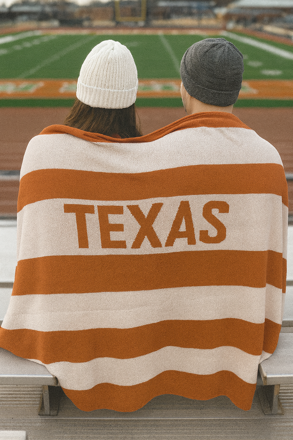 Knit Throw - Multi Stripe Texas featuring horizontal orange and cream stripes with the word “TEXAS” in large letters.