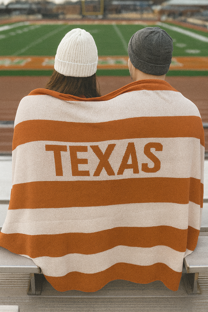 Knit Throw - Multi Stripe Texas featuring horizontal orange and cream stripes with the word “TEXAS” in large letters.