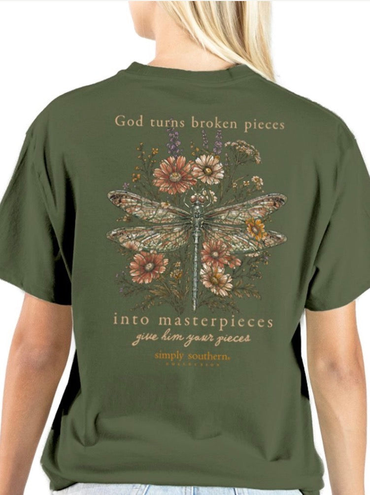 God Turns Broken Pieces T-Shirt in olive green, featuring a dragonfly, flowers, and the text: “God turns broken pieces into masterpieces. Give Him your pieces. Simply Southern.” Available in sizes S-XXL.