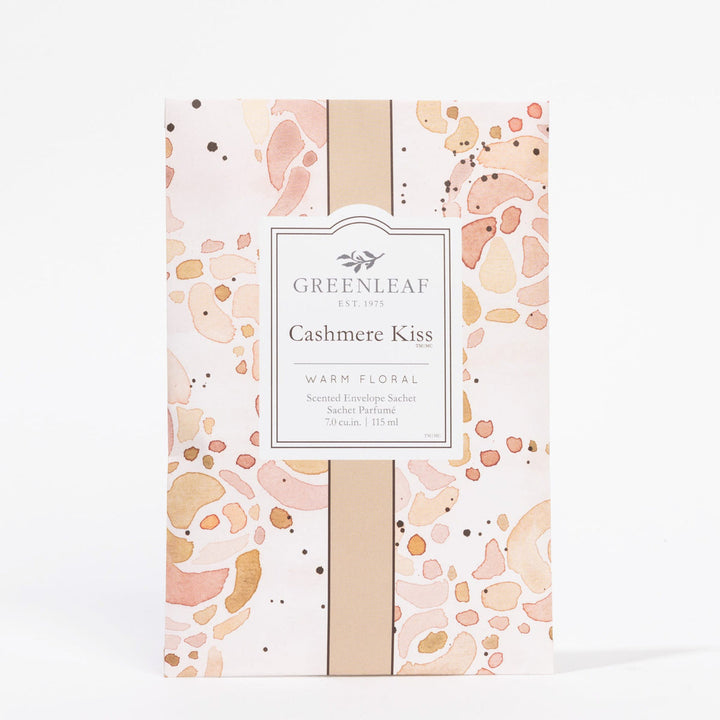 Cashmere Kiss Sachet with warm floral scent in pink, peach, and gold packaging. Available in standard sachet size.