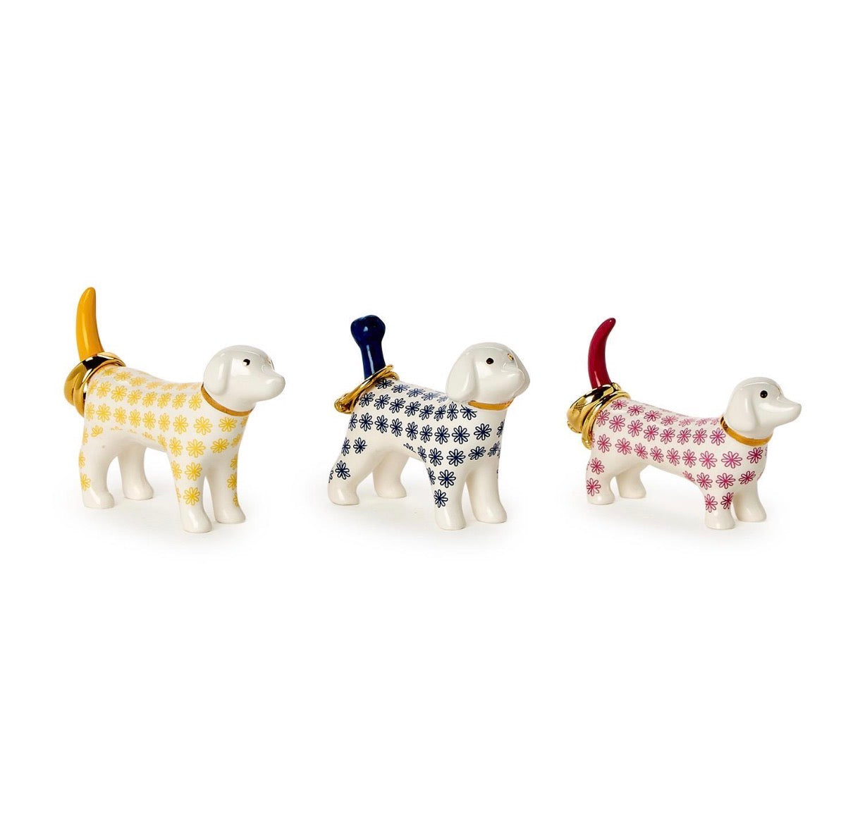 The Posh Pooch Dog Ceramic Ring Holder set includes three small ceramic dog figurines with gold collars and brightly colored floral-patterned tails in yellow, blue, and red. Sizes available: small.