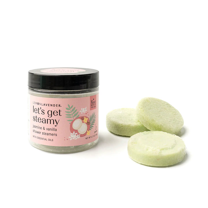 Jar labeled "Let’s Get Steamy Shower Steamers | Lemon Lavender." Available in sizes: 4oz, 8oz. Contains pale green tablets.