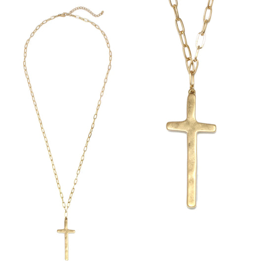 The Bernie Cross Pendant Necklace features a large, minimalist gold cross pendant on a gold chain; close-up detail of the cross and chain shown. Available in 16", 18", and 20" sizes.