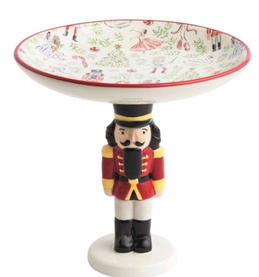 Nutcracker candy dish on a pedestal base with a shallow, Nutcracker-illustrated bowl.
