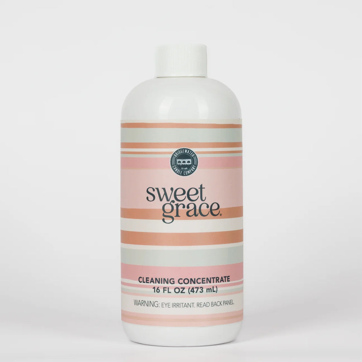 Sweet Grace Cleaning Concentrate, 16 fl oz (473 mL), with pink and beige stripes and a label warning: “Eye irritant. Read back panel.”.