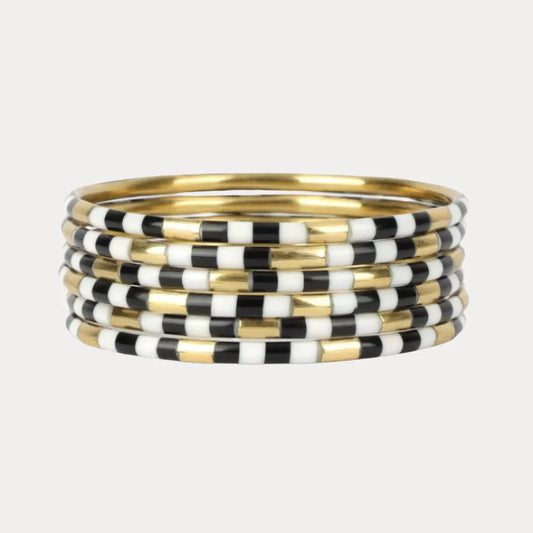 Set of seven thin enamel bangles with black and white checkerboard pattern, available in multiple sizes.