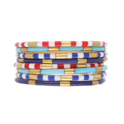 Colorful enamel Firecracker Veda Stack bracelets with red, white, blue, light blue, and gold striped beads; available in S/M/L.
