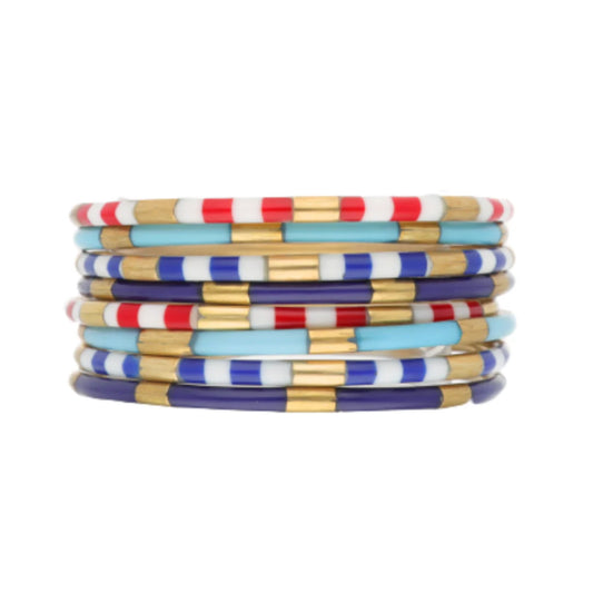 Colorful enamel Firecracker Veda Stack bracelets with red, white, blue, light blue, and gold striped beads; available in S/M/L.
