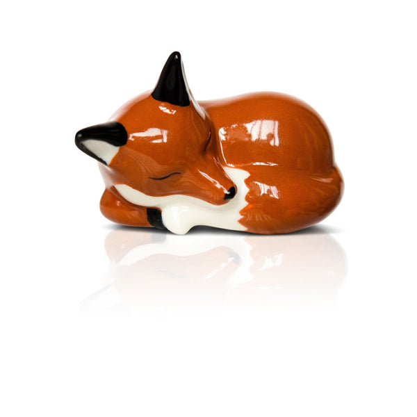 Ceramic orange fox figurine with black ears and white belly, curled up asleep. Available in small and large sizes.