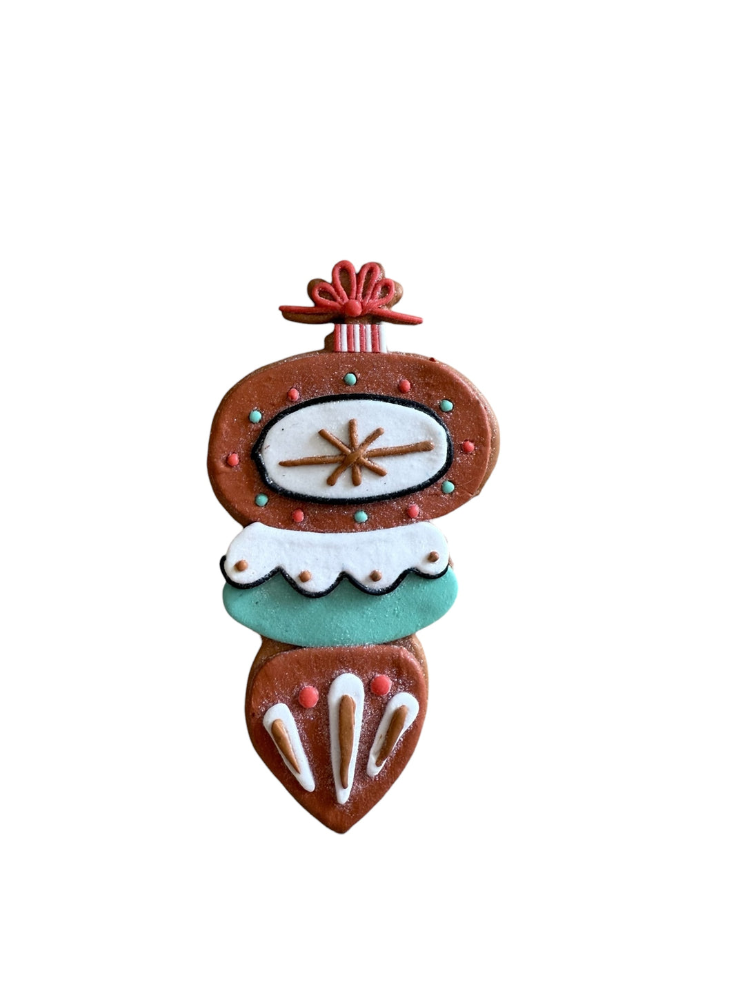 Tiered clay dough ornament with a brown, white, and teal geometric design and red bow.