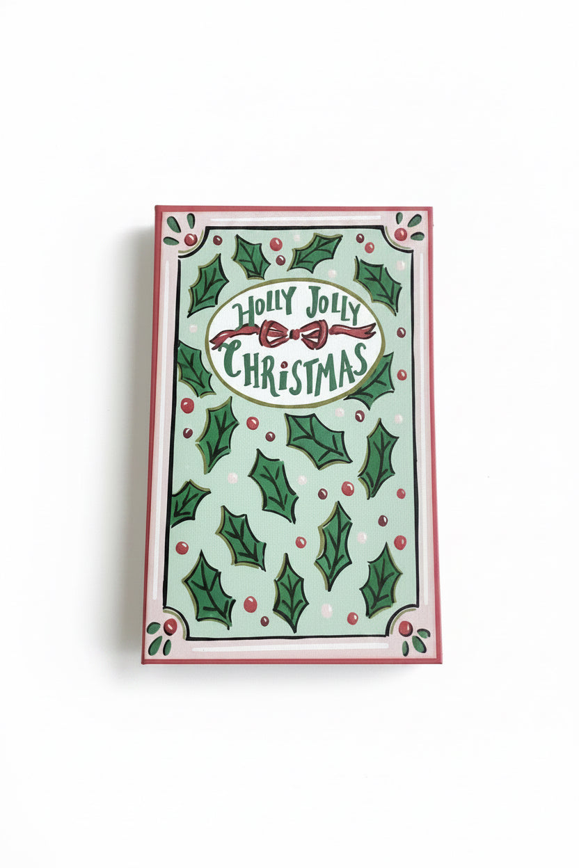 Rectangular canvas book storage box in light green with holly leaf pattern, red bow, and “Holly Jolly Christmas” text.