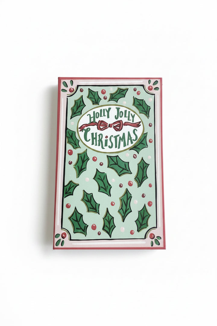 Rectangular canvas book storage box in light green with holly leaf pattern, red bow, and “Holly Jolly Christmas” text.
