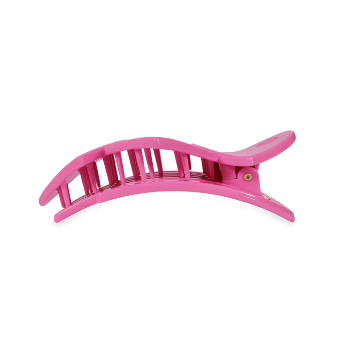 Pink plastic bendable hair clip with curved, vented design and hinge; available in multiple sizes; suitable for all hair types.