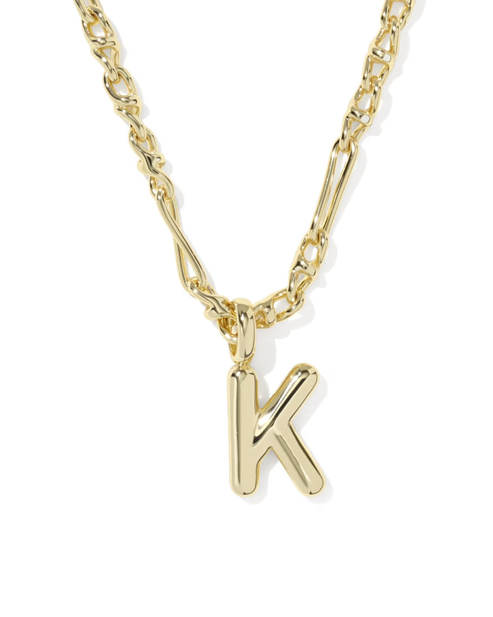Bubble Letter Necklace by Kendra Scott with a shiny gold "K" pendant on a stylish chain; available in small, medium, and large sizes.