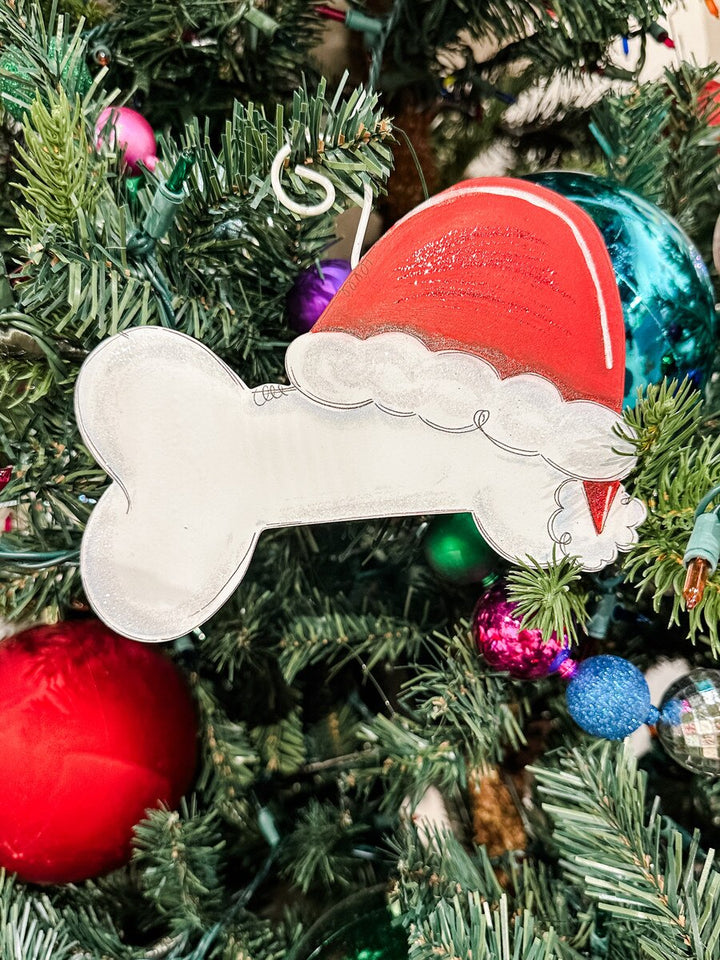 Dog Bone Santa ornament shaped like a dog bone wearing a red Santa hat.
