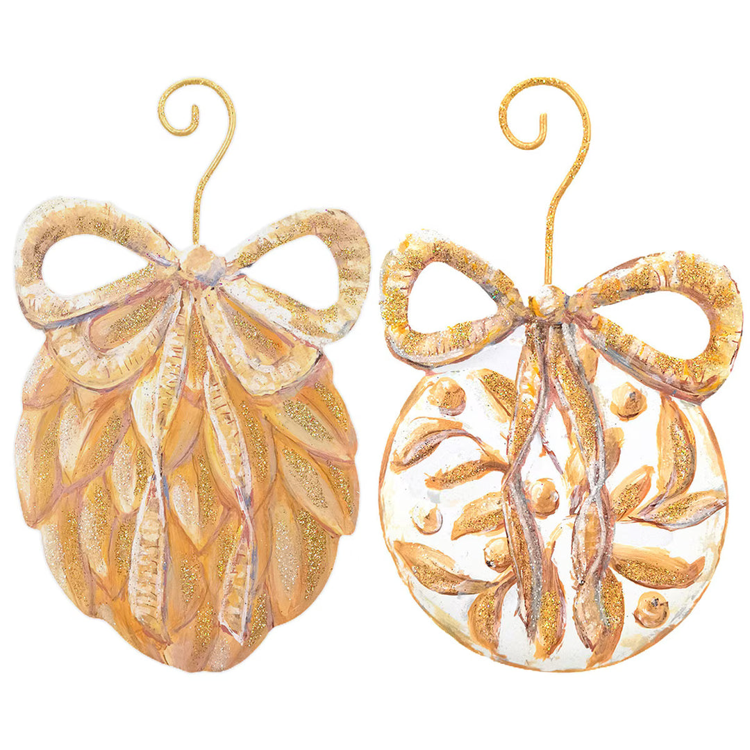 Two golden ornaments: a bow-topped pinecone and a round leaf-motif bauble. 2 styles available.