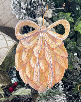 Gold teardrop-shaped ornament with a bow topper and textured leaf layers.