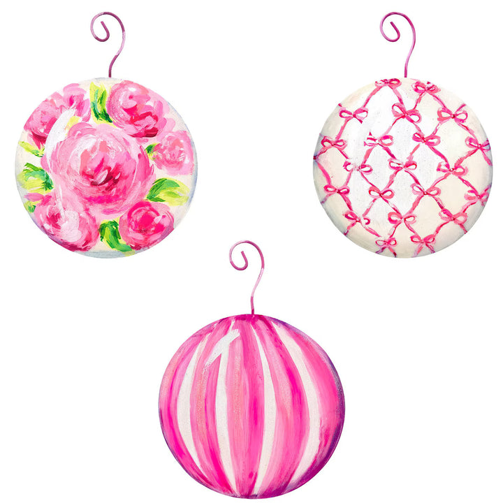Three pink fanciful ball ornaments with rose, lattice, and stripe patterns.