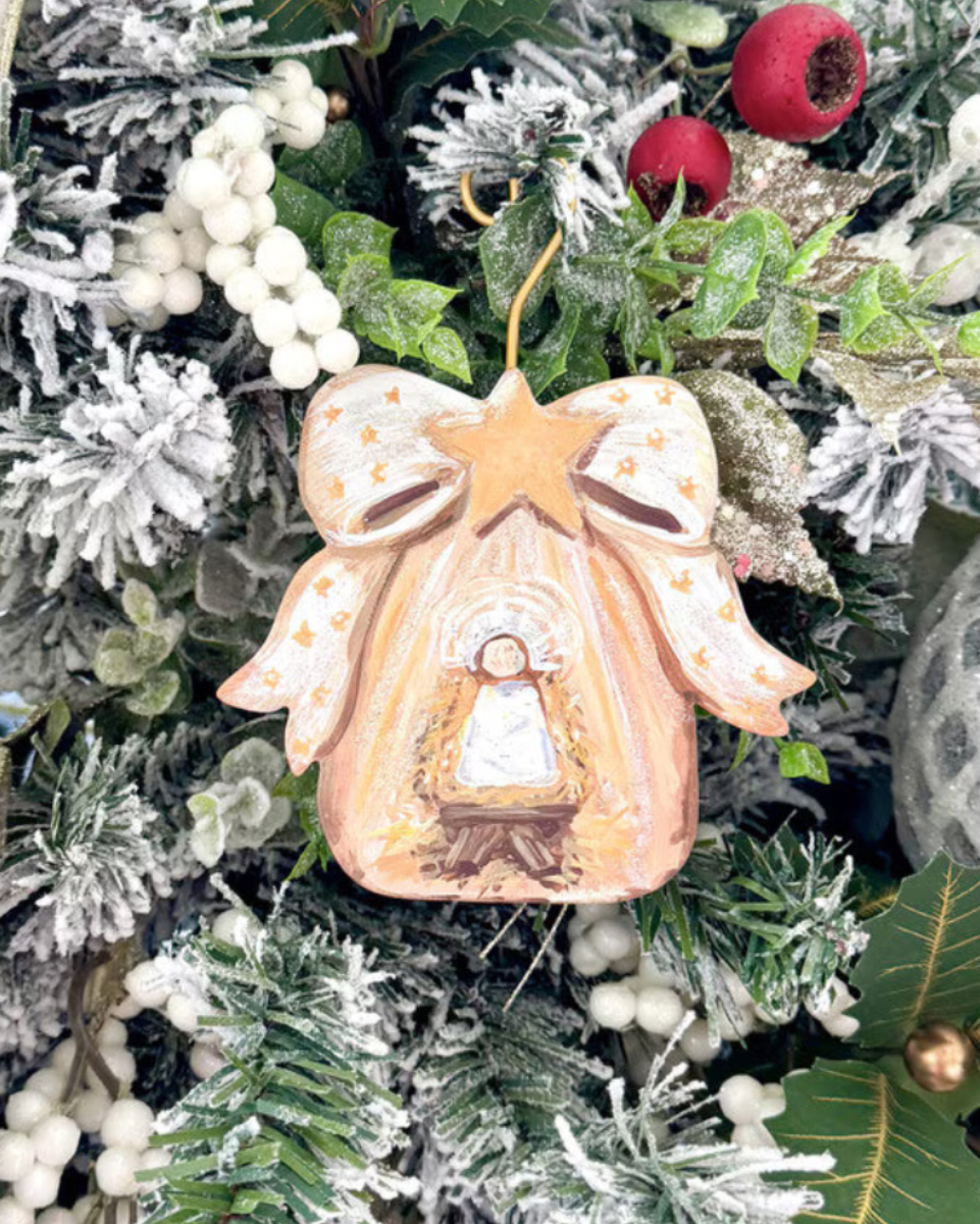Gold Bow Manger & Baby Jesus ornament with bell-shaped nativity scene and star bow.