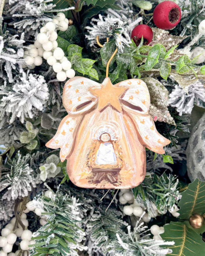 Gold Bow Manger &amp; Baby Jesus ornament with bell-shaped nativity scene and star bow.