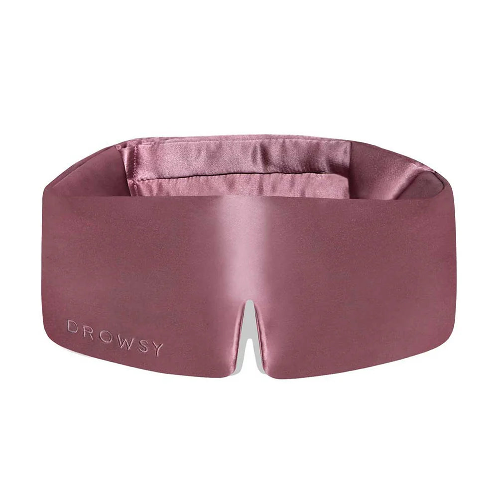 Pink silk Drowsy Sleep Mask with "DROWSY" embossed, wide padded shape, center notch; available in one size.