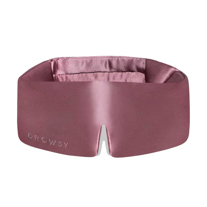 Pink silk Drowsy Sleep Mask with "DROWSY" embossed, wide padded shape, center notch; available in one size.