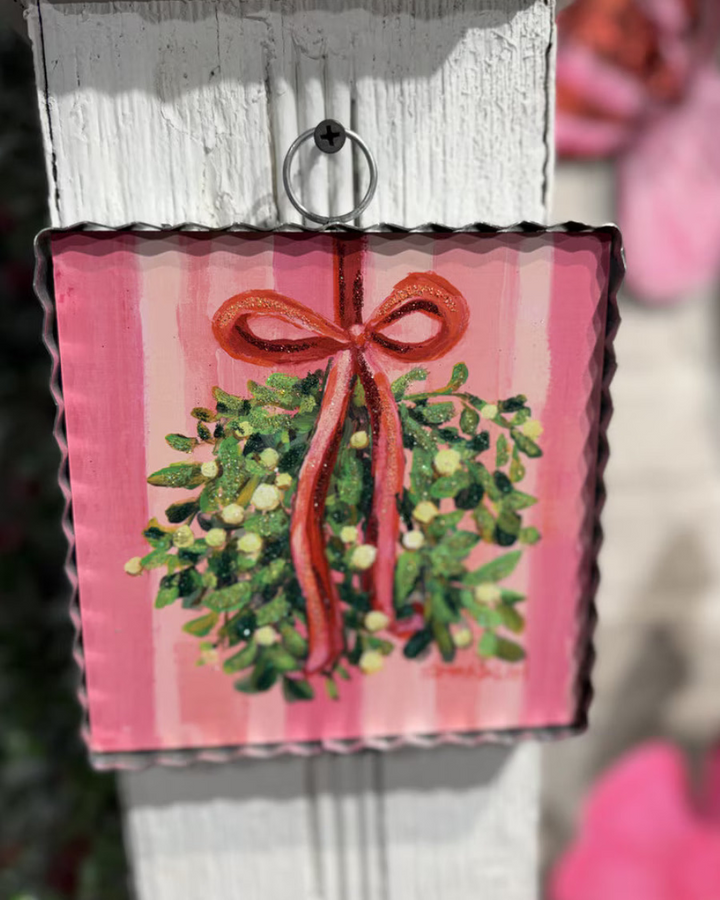 Mini Gallery Art Mistletoe square metal sign featuring mistletoe art tied with a red ribbon. Available in square sizes.