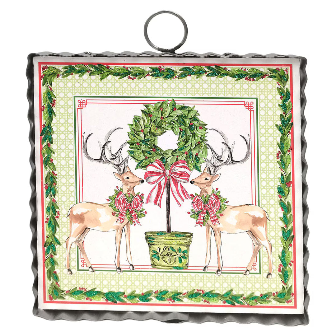 Mini Gallery Art Traditional Tidings Deer &amp; Topiary square metal wall art with two deer, a potted topiary wreath, and a greenery border. Available in square.