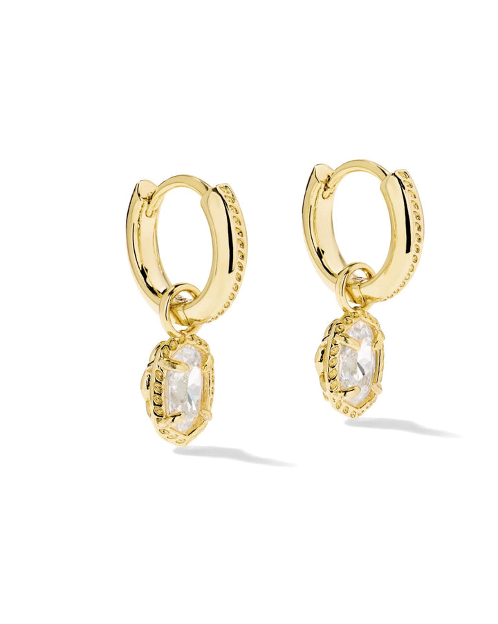 Mini Ella Luxe Huggie CZ Earrings: gold huggie hoops with a dangling, faceted marquise-cut clear stone in a beaded setting.