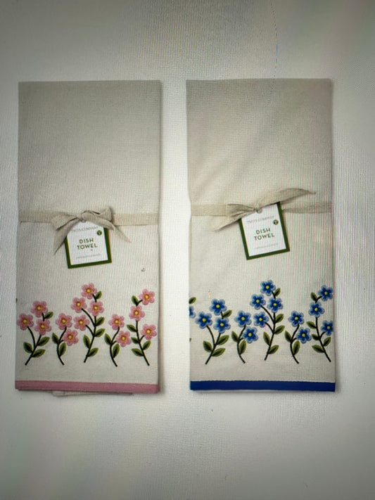 Two Forget-Me-Not dish towels with pink and blue flower embroidery, tag, and ribbon. Available in 16"x28".