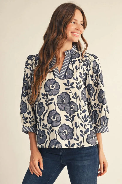 Bonnie Ruffle Floral Blouse in blue floral pattern, available in sizes XS–XL.